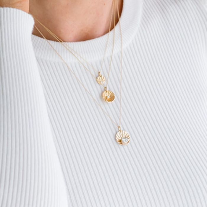 Model wearing 14K gold Shine necklaces