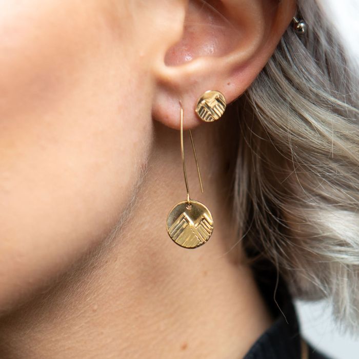 model wearing 14K gold mountain stud earrings