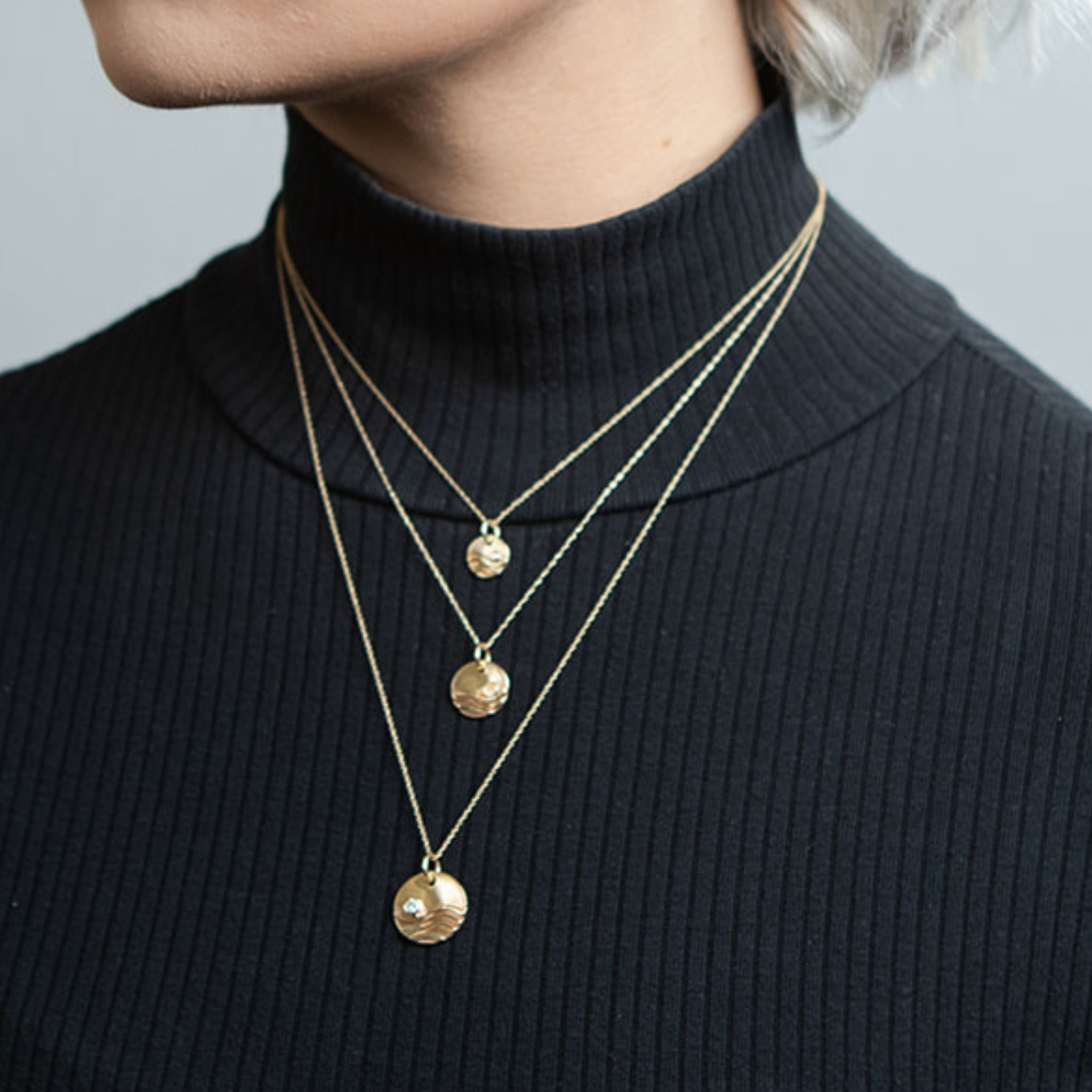Model wearing gold reflections necklaces