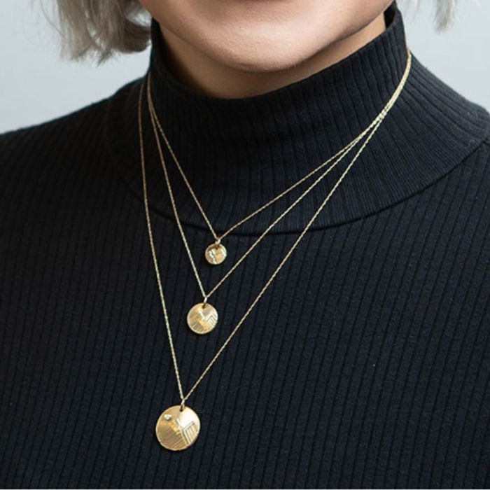 Model wearing 14K gold mountain necklaces