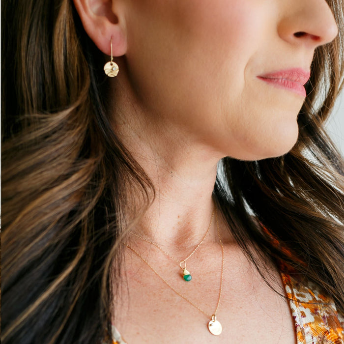 Gold reflections charm earrings on model