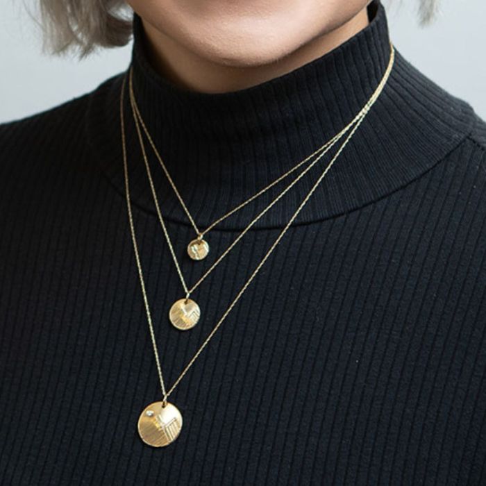 Model wearing 14K gold charm necklace