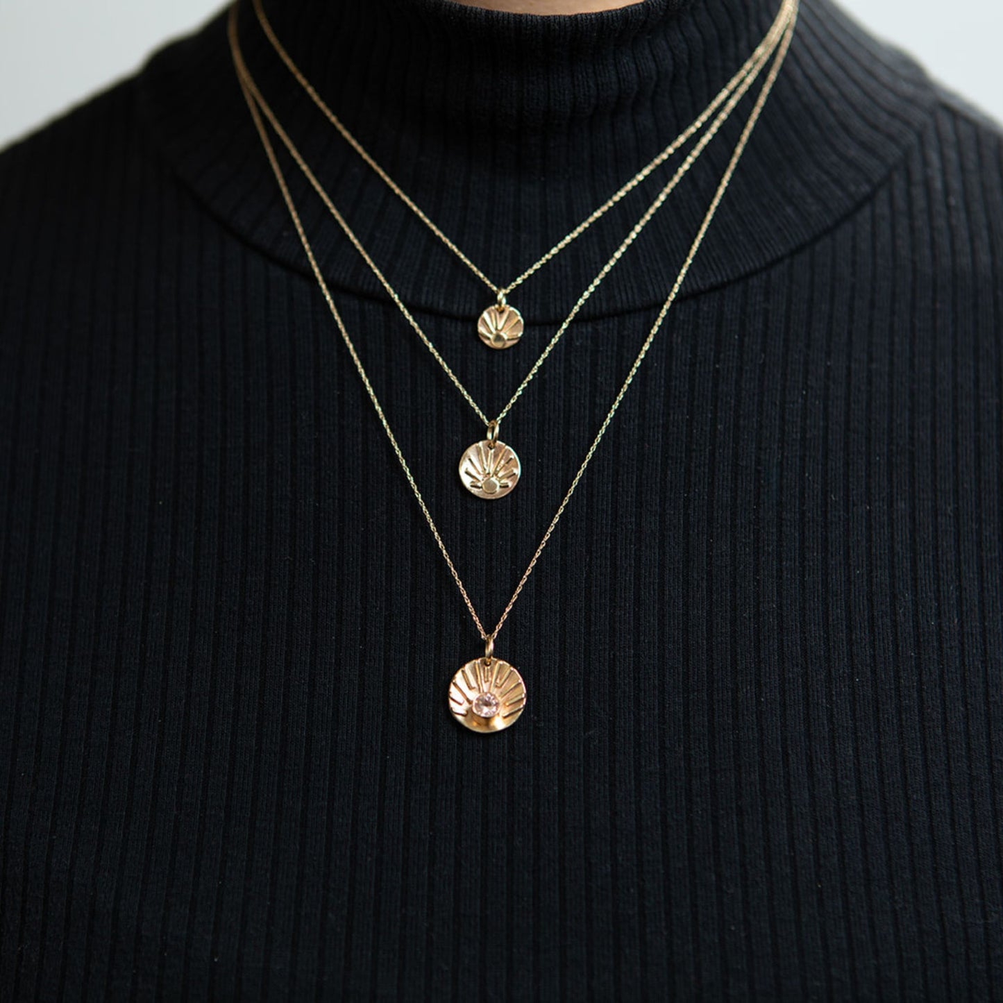 Close up of model wearing shine charm necklace