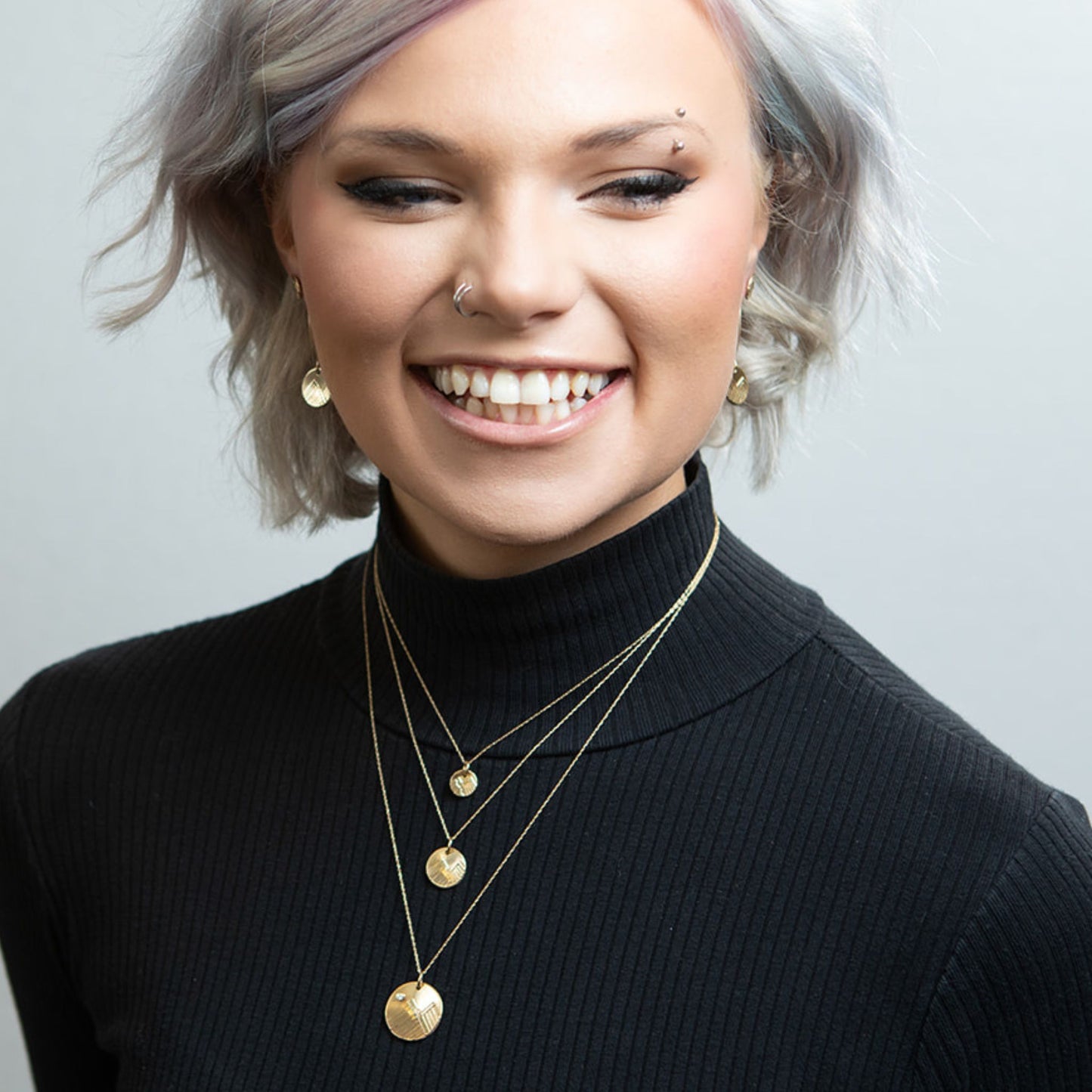 Model wearing gold mountain love necklaces