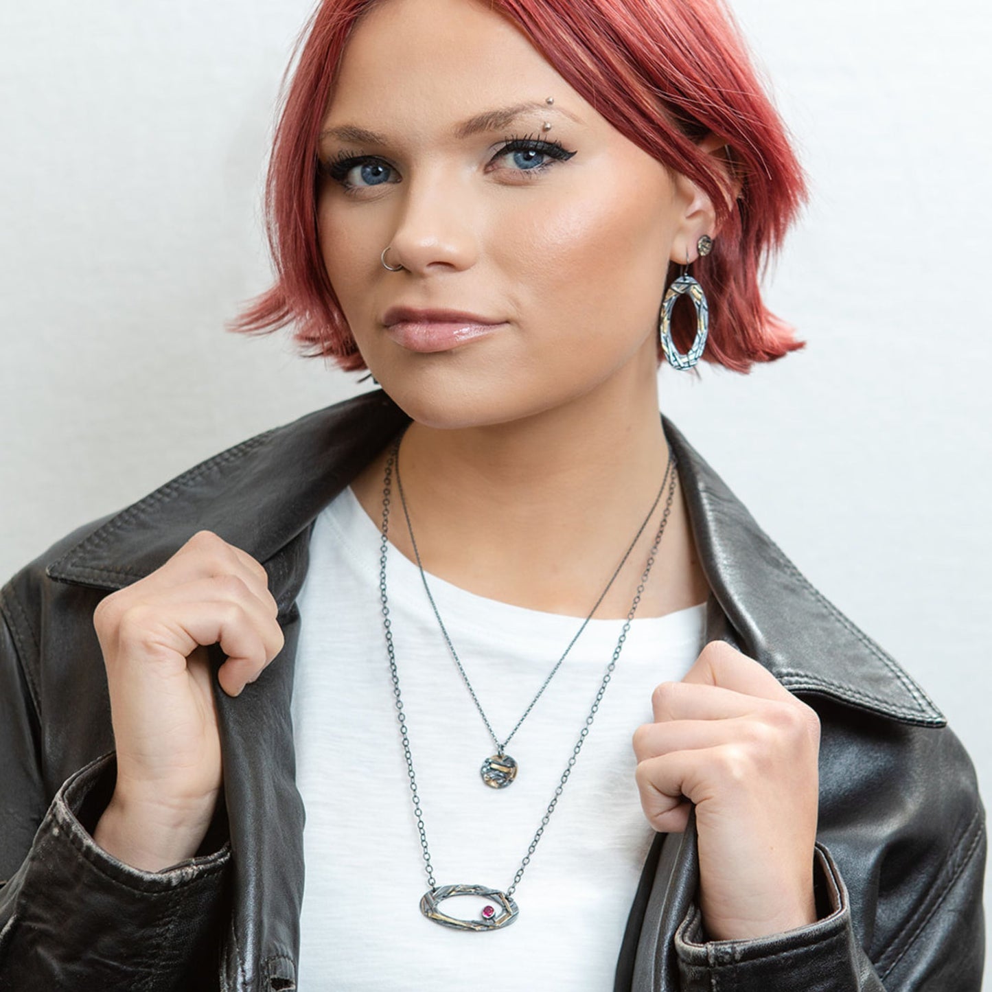 Oval mixed metal earrings on model