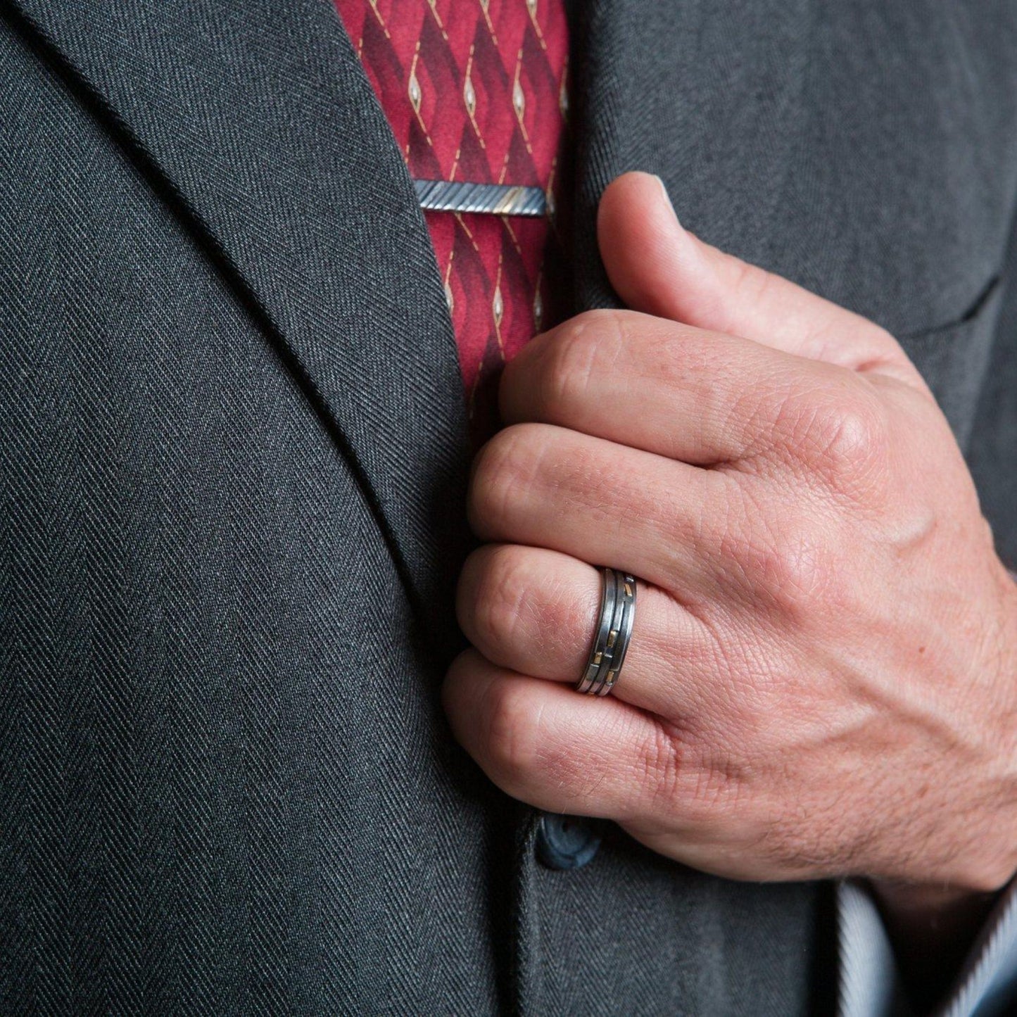 Oxidized silver and gold ring band on male model