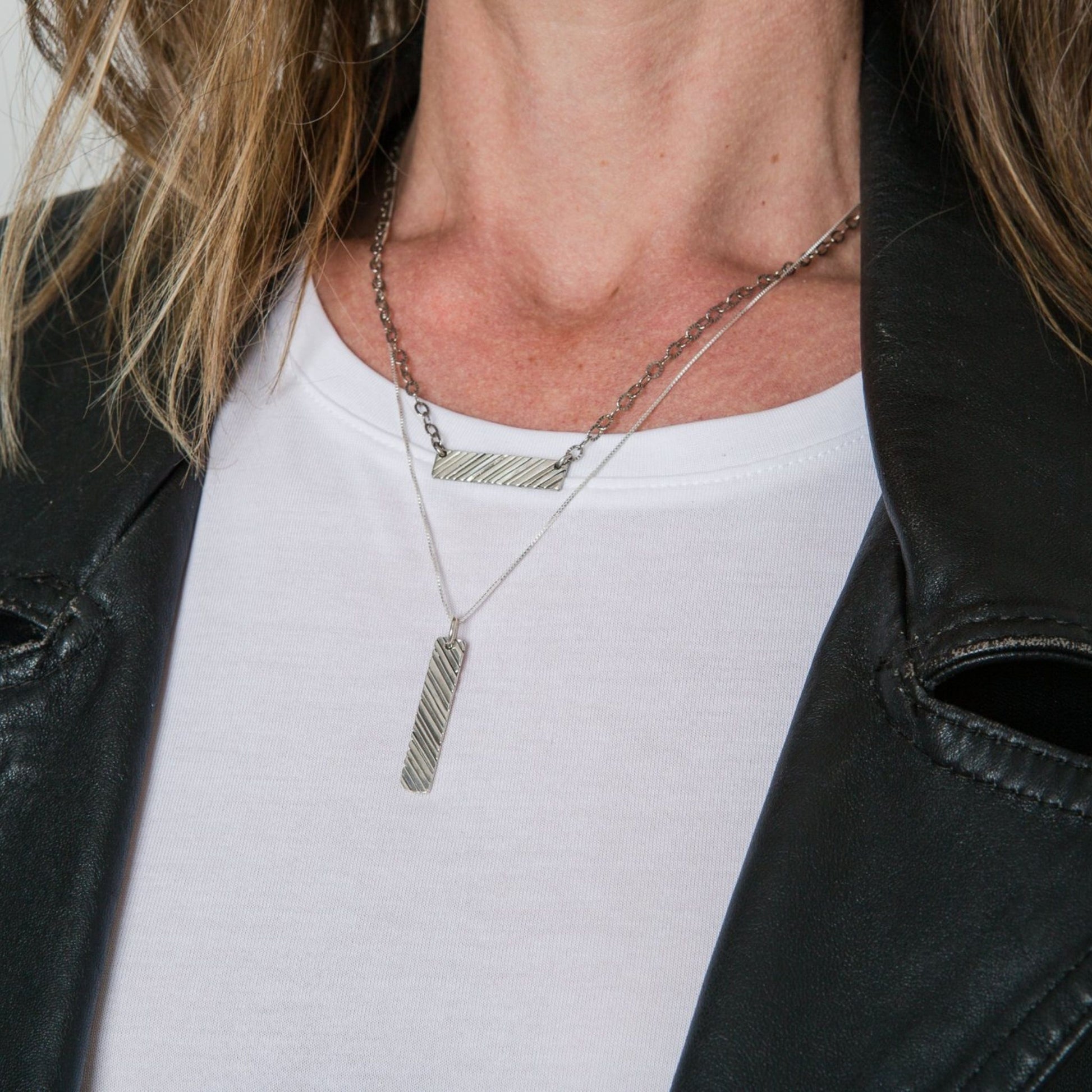 Model wearing silver bar necklace