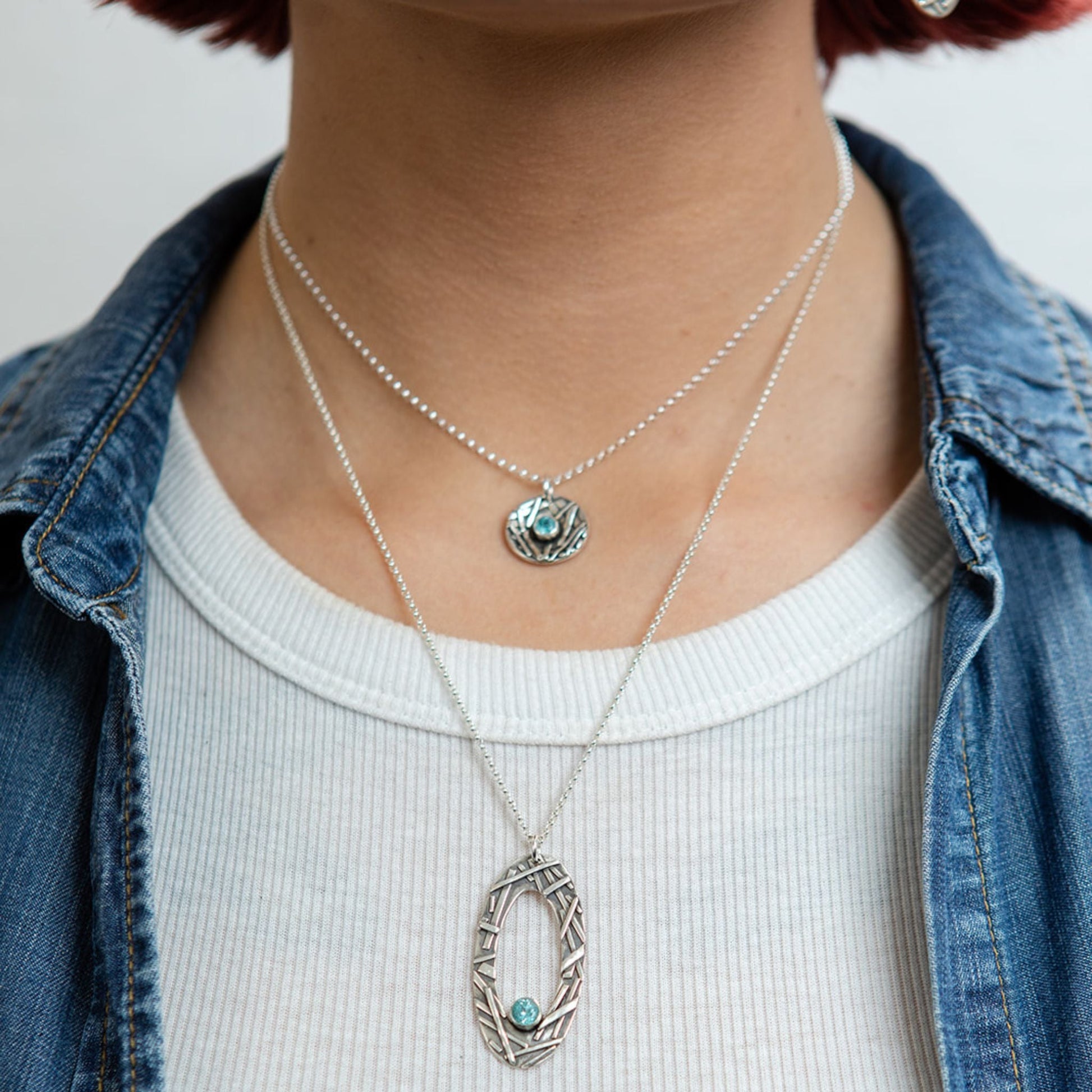 Blue apatite oval necklace closeup on model