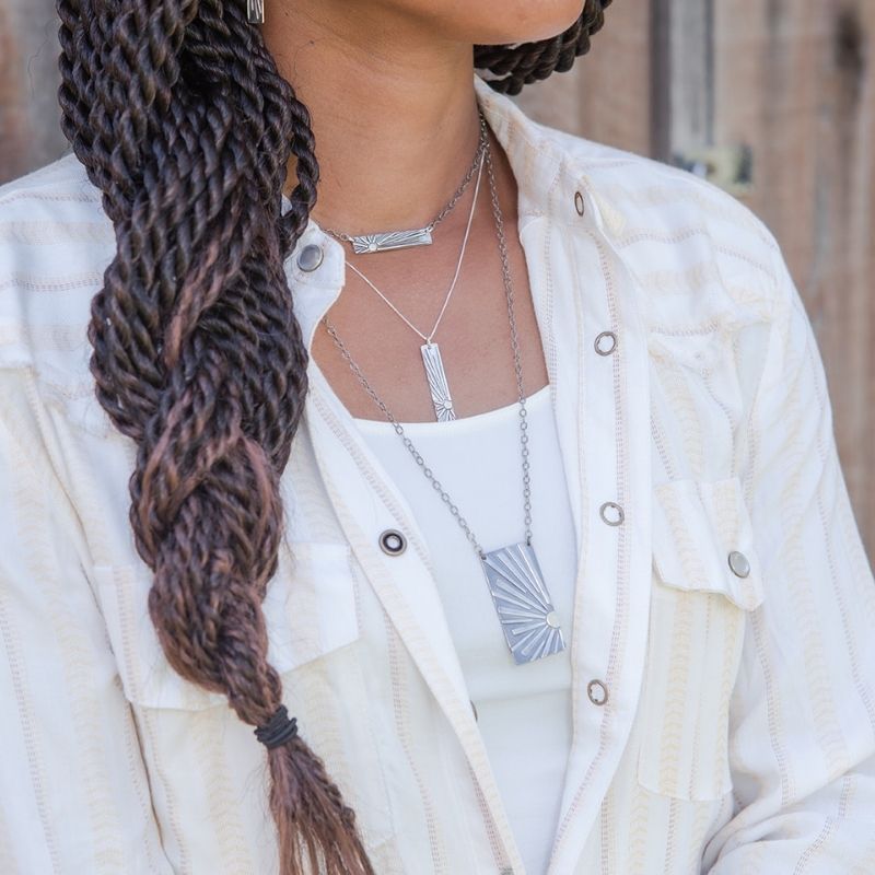 Model wearing shine necklaces
