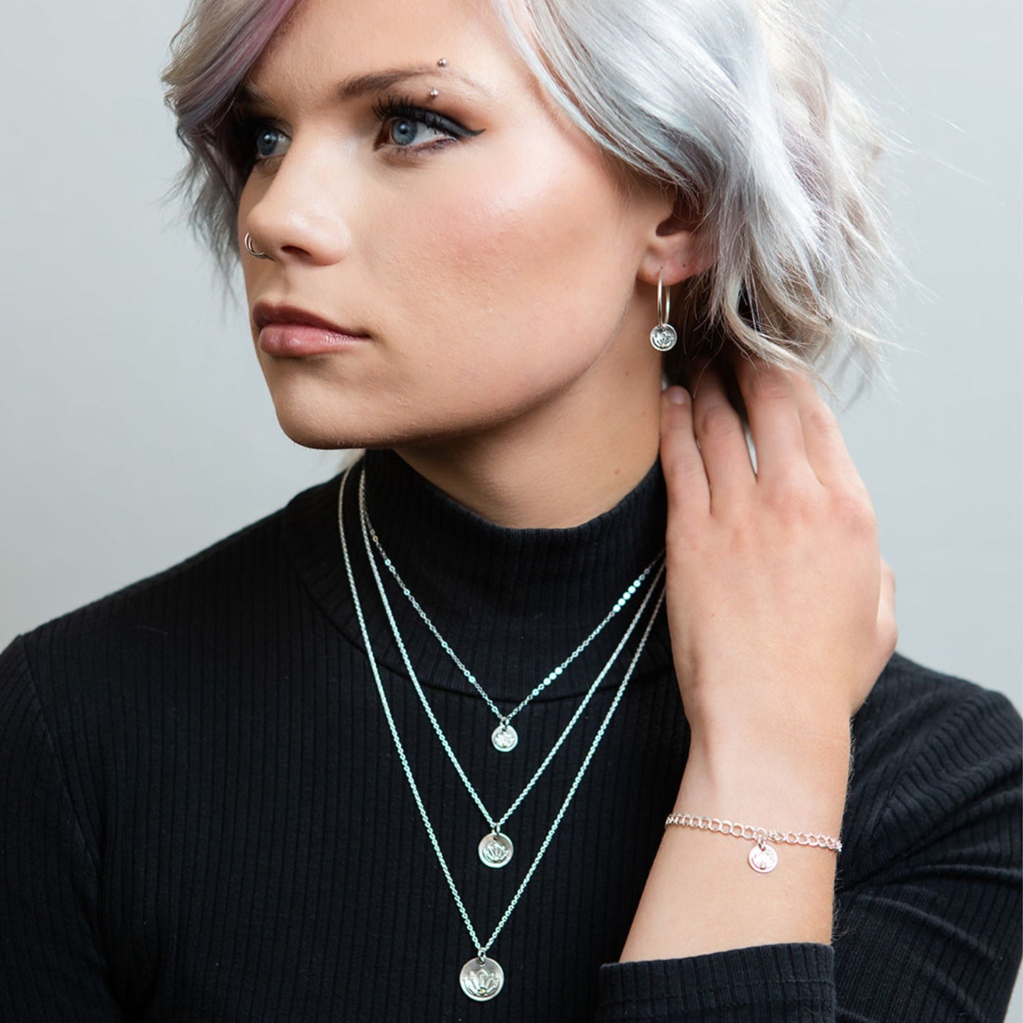 Model wearing silver lotus necklace