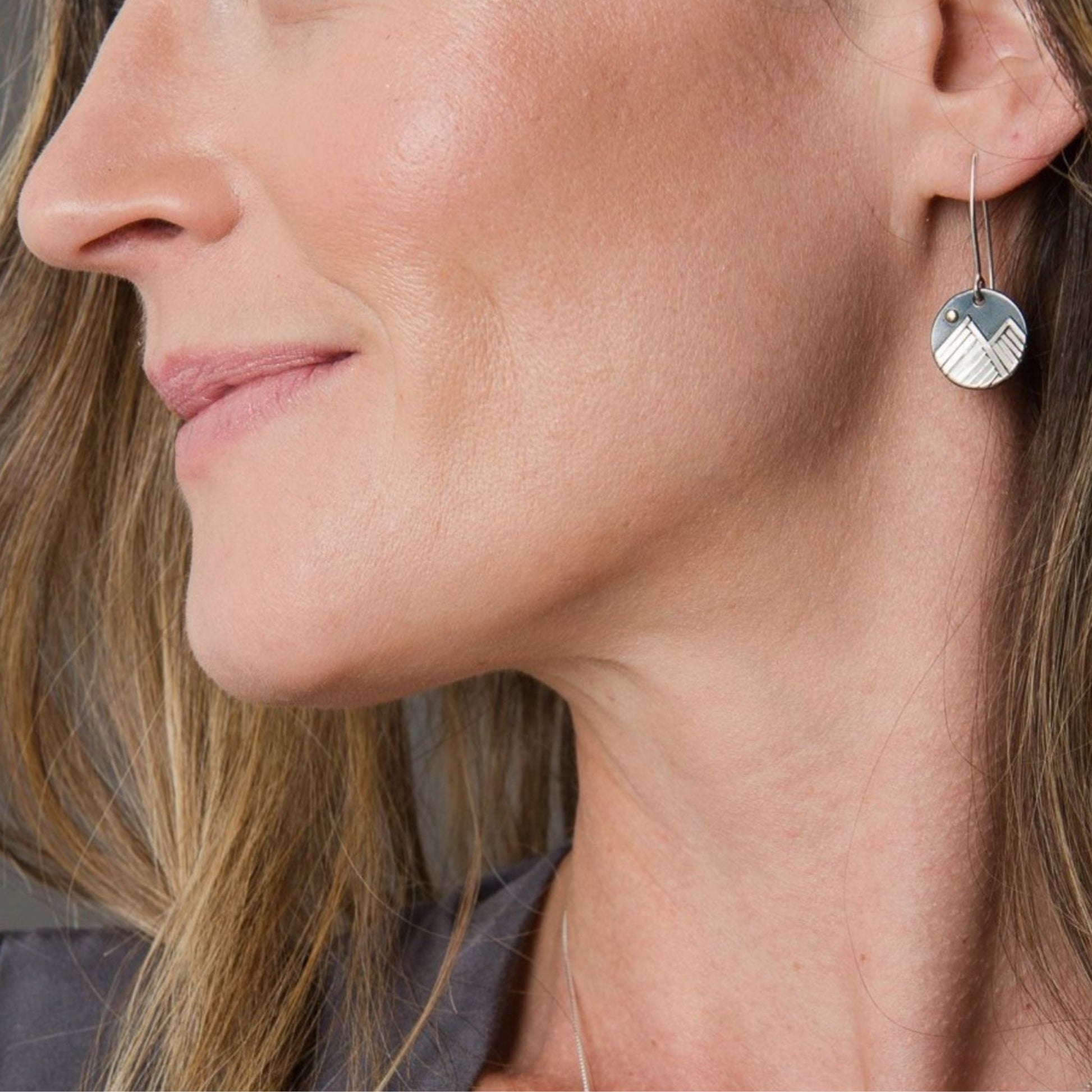 Mountain dangle earrings on model