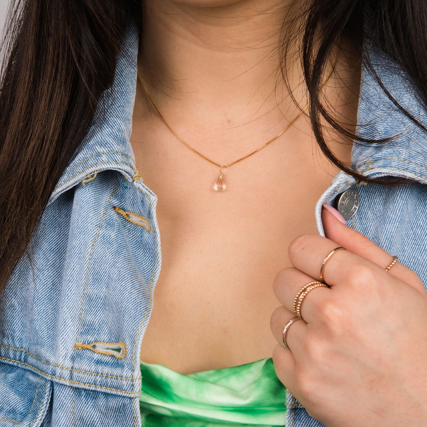 Model wearing April gold birthstone necklace