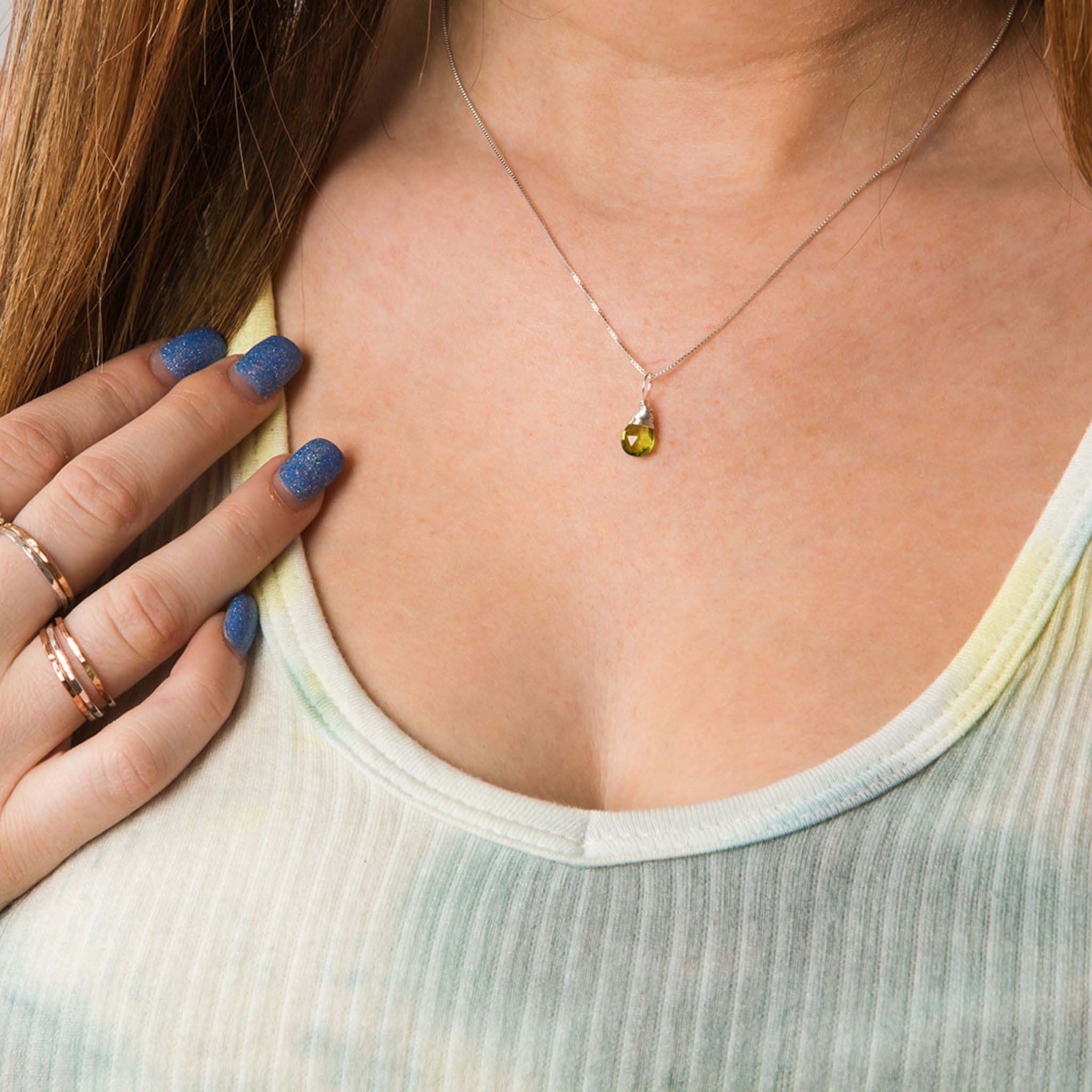 Model wearing August birthstone silver necklace