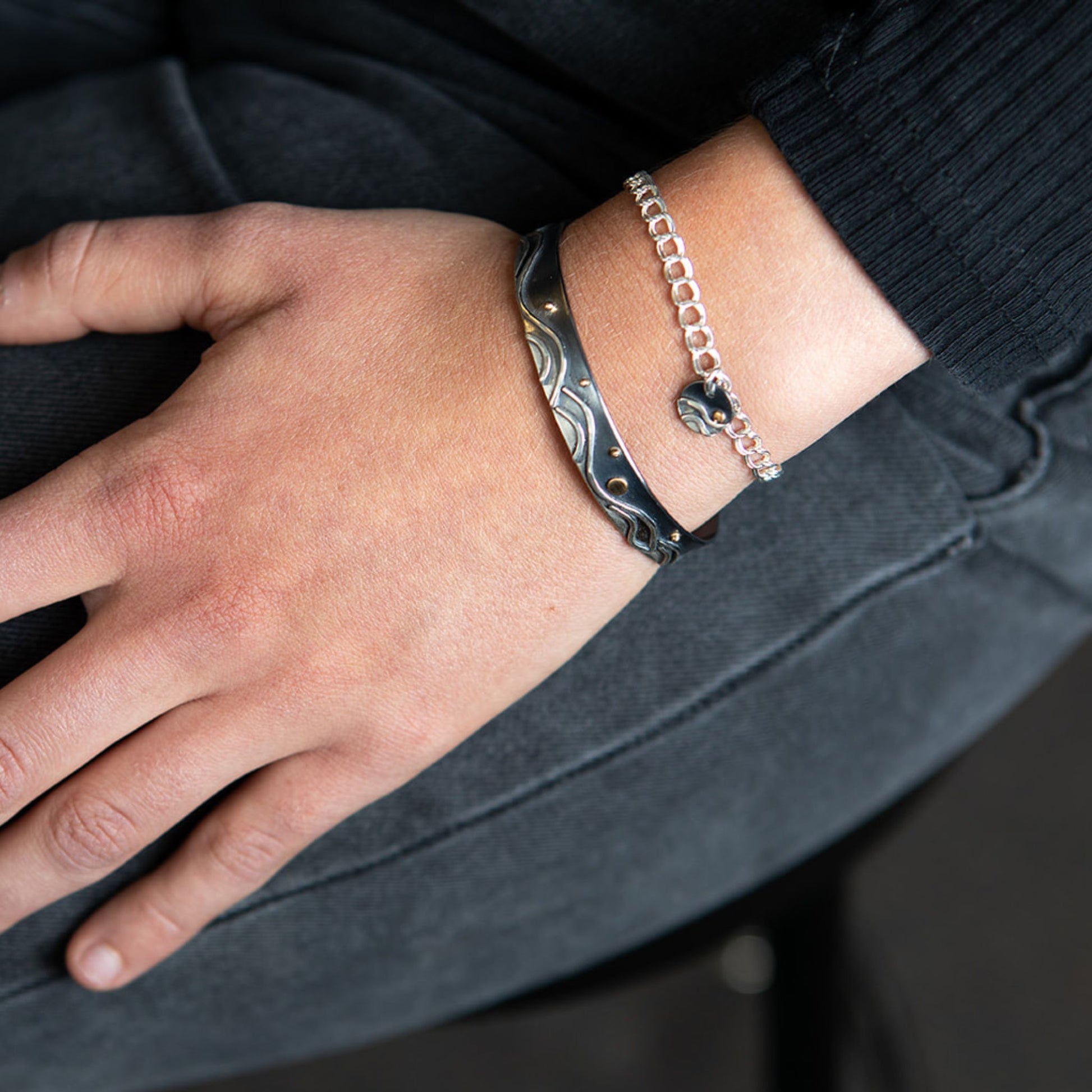 Closeup of model wearing Reflections skinny cuff bracelet