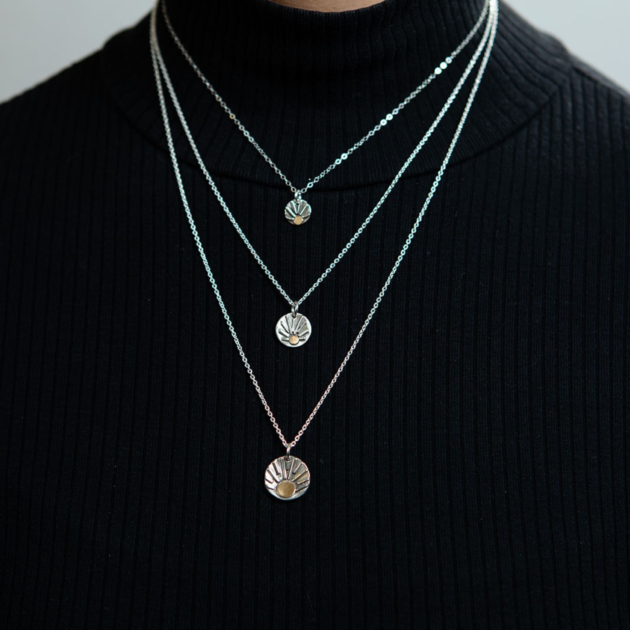 Closeup of model wearing shine necklaces