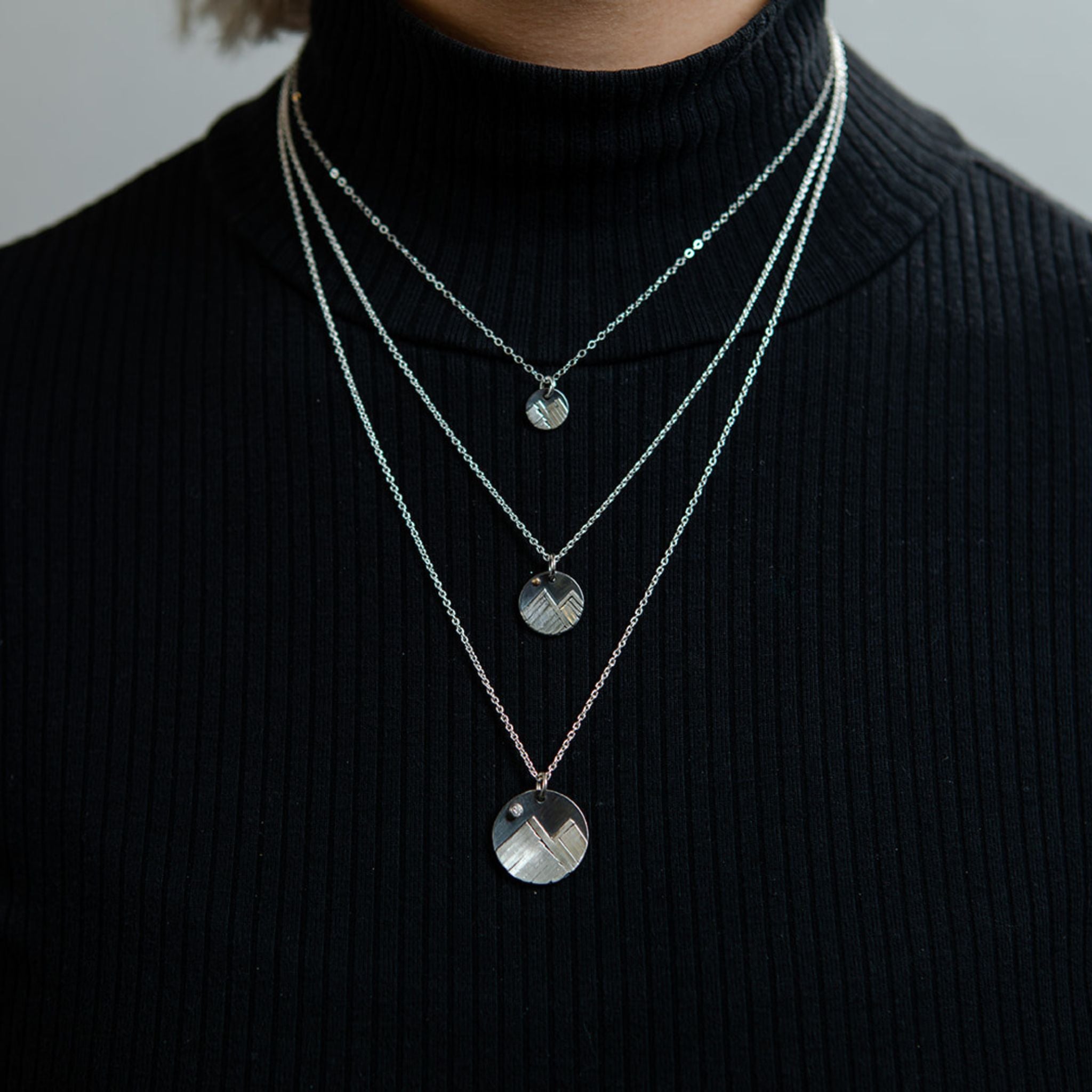 Closeup of model wearing diamond mountain necklace