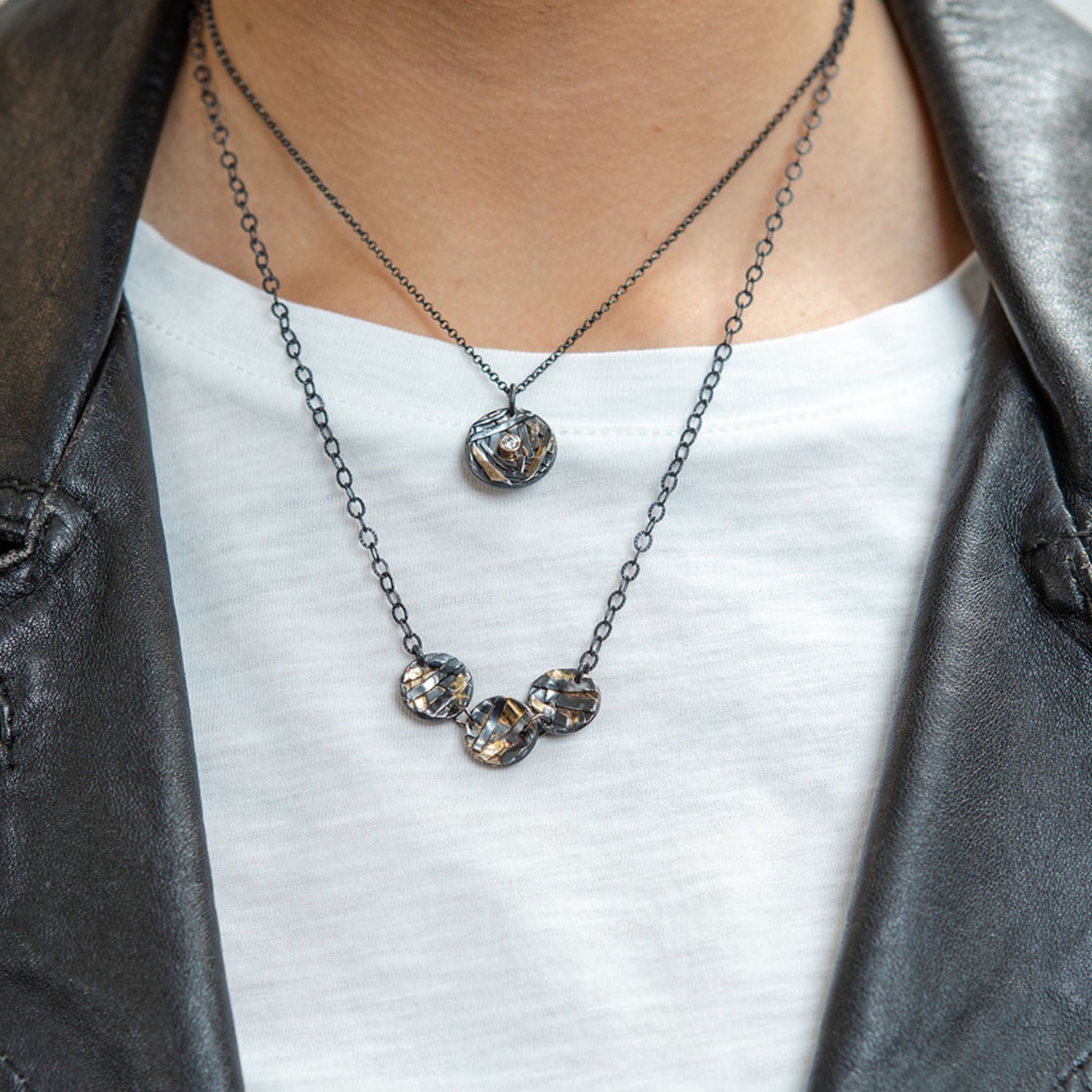 Diamond coin necklace closeup on model
