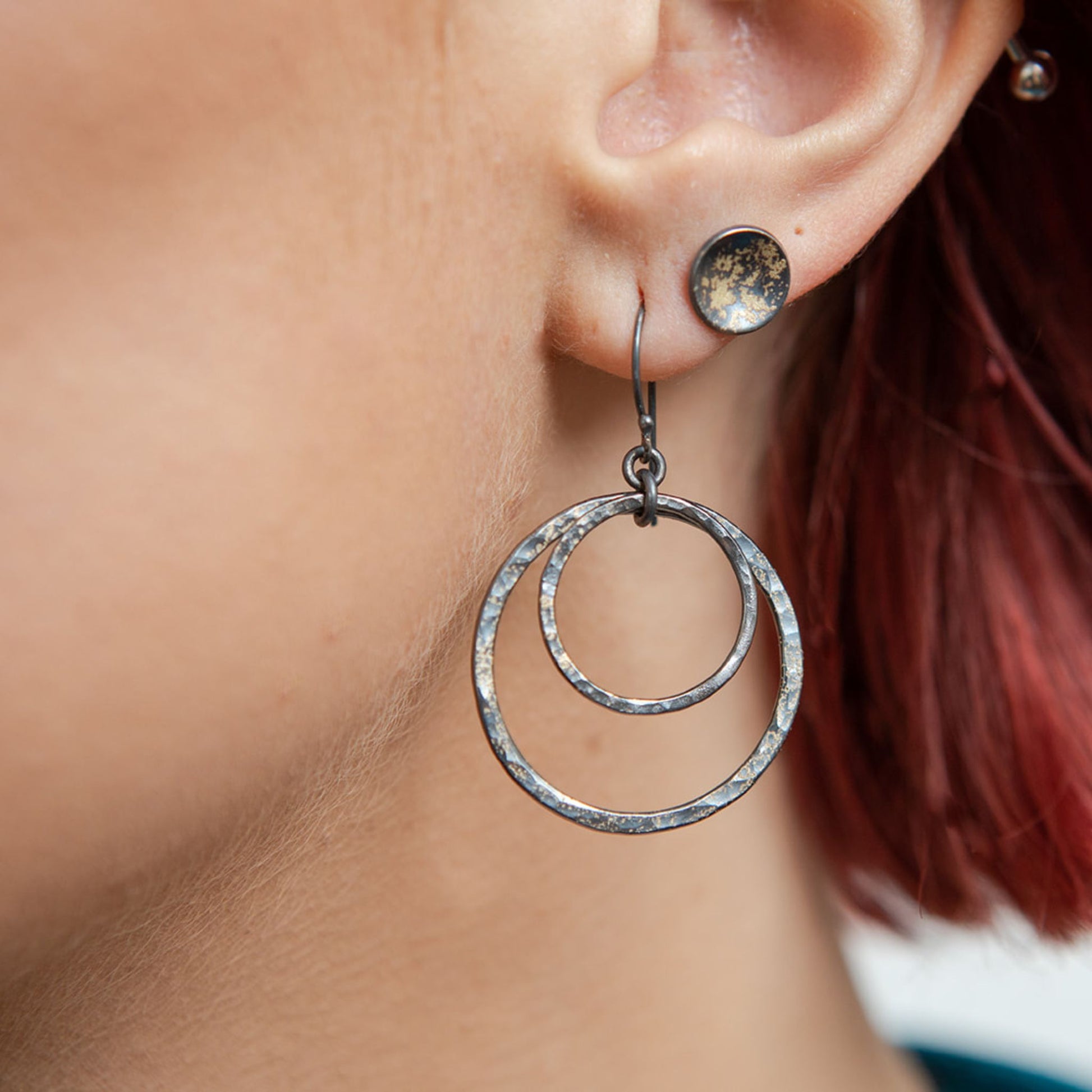 Galaxy hoop earrings closeup on model