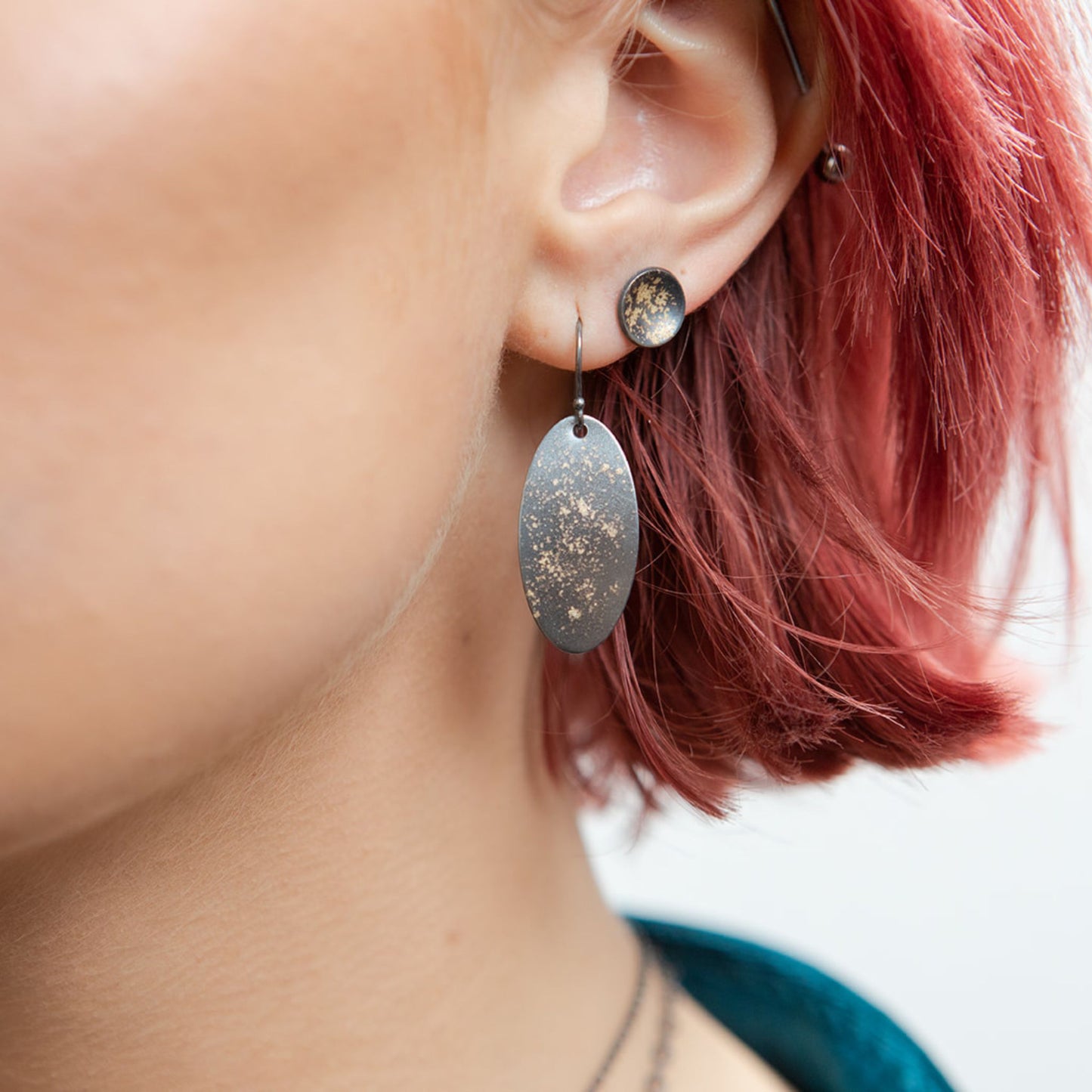 Galaxy oval earrings closeup on model