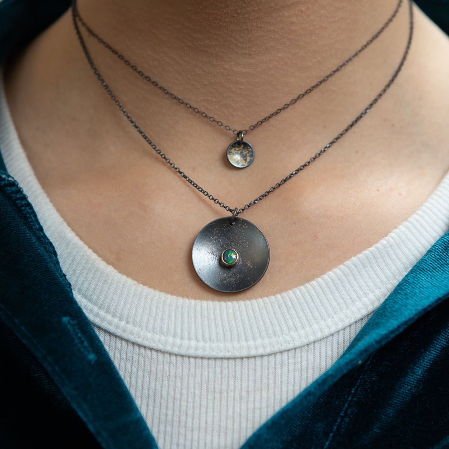 Galaxy black opal necklace closeup on model