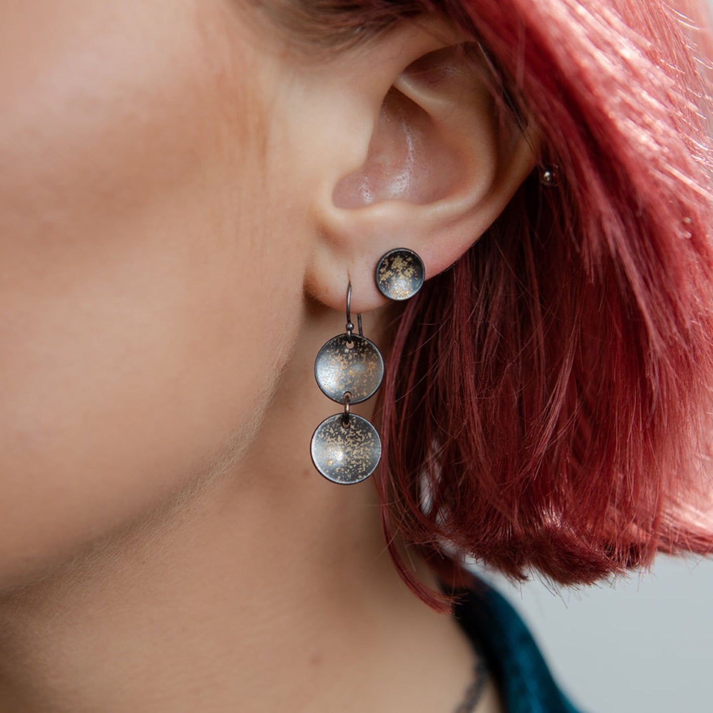 Galaxy coin stud earrings on model