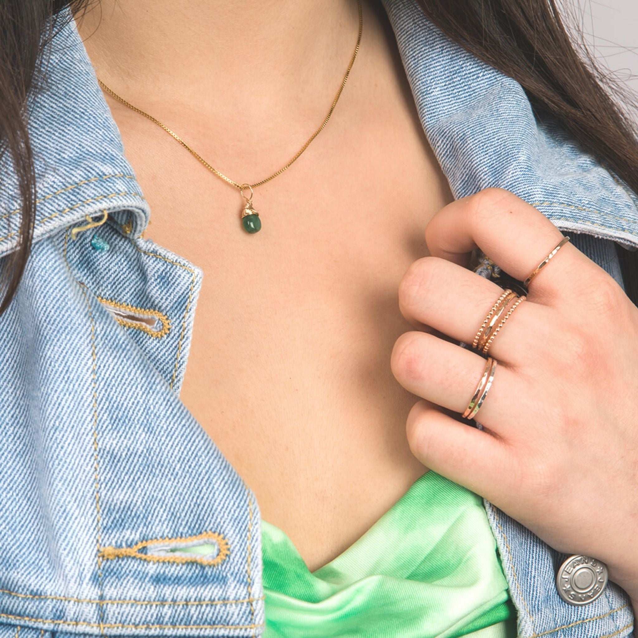 Model wearing May gold birthstone necklace