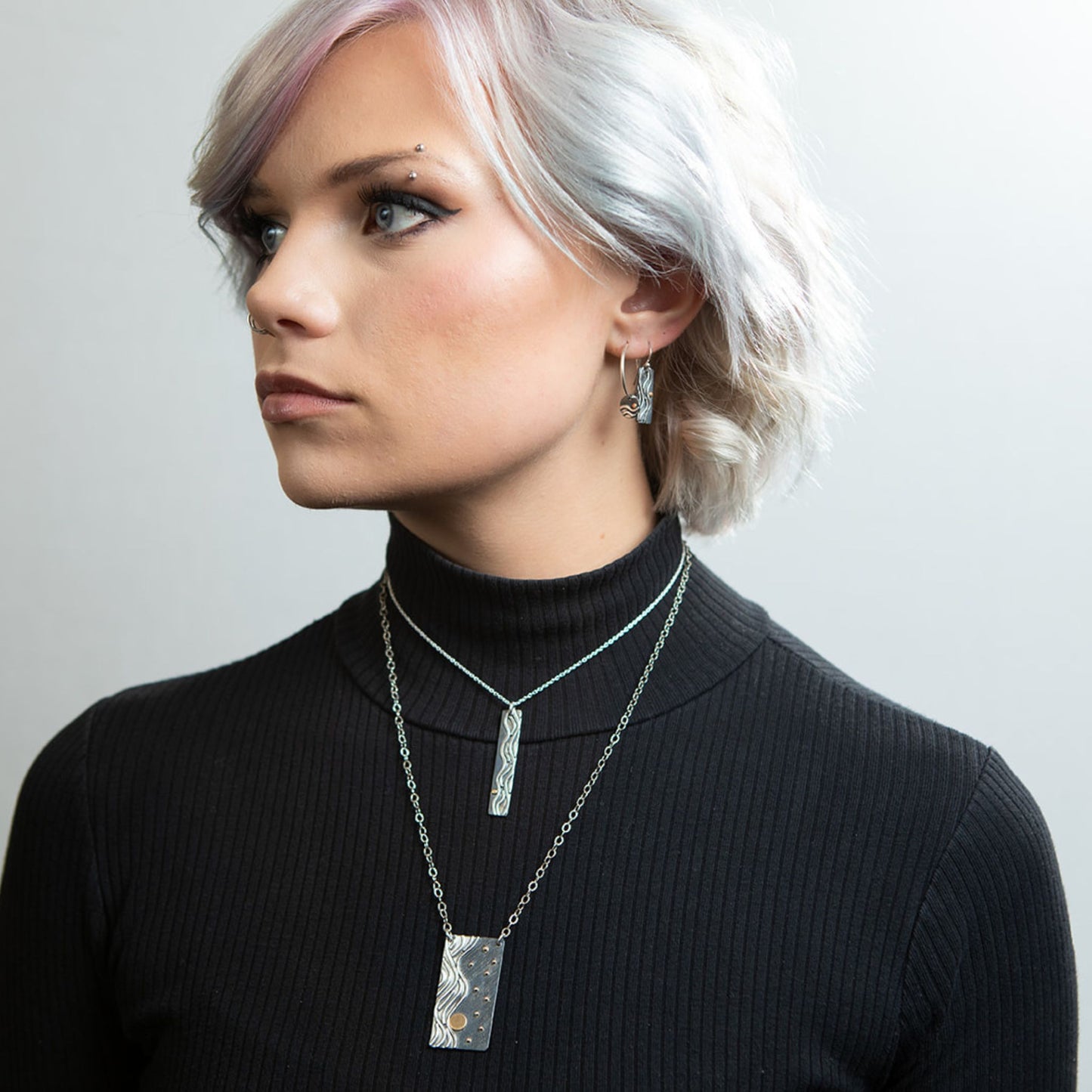 Model wearing Reflections necklaces