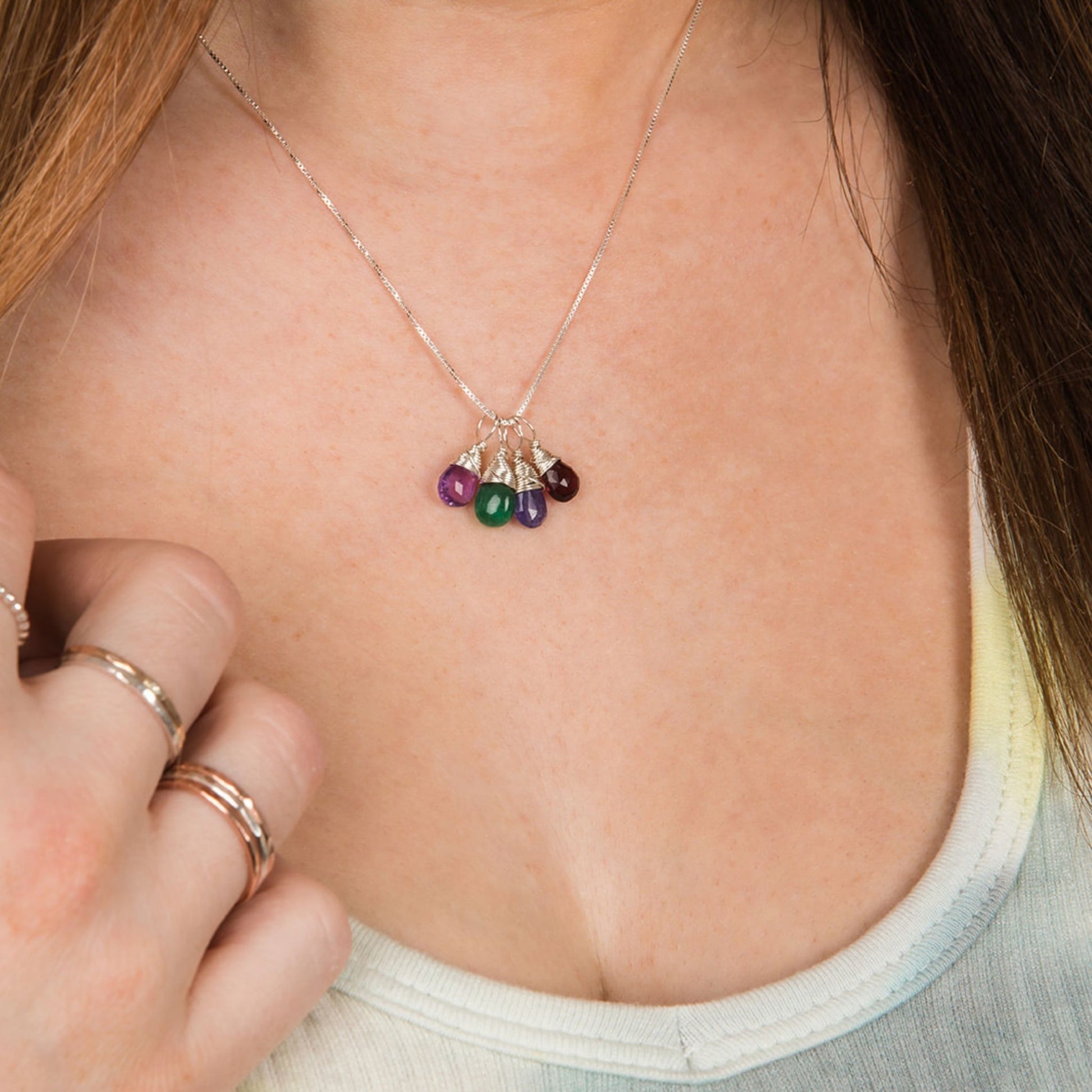 Mom silver necklace with four birthstones on model